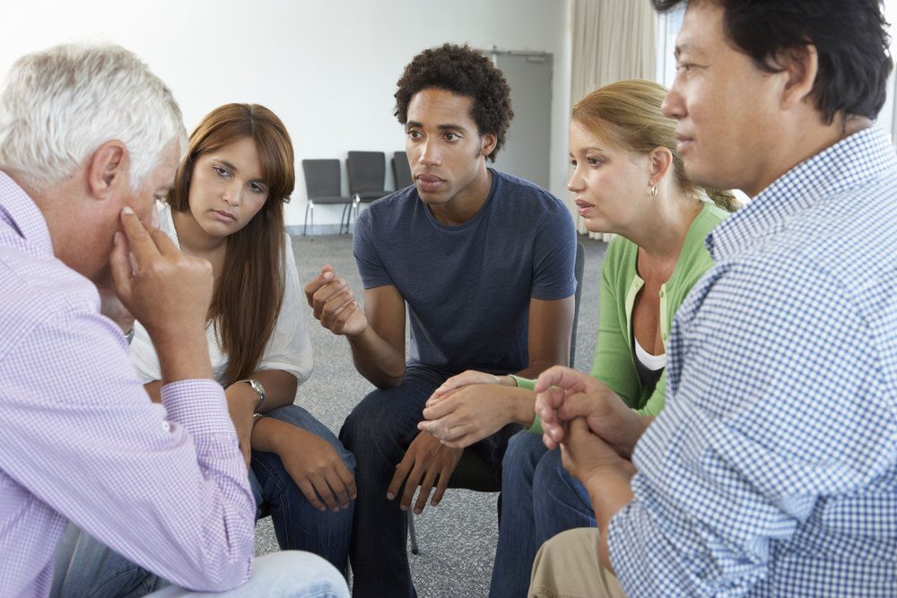 people chatting at an AA meeting